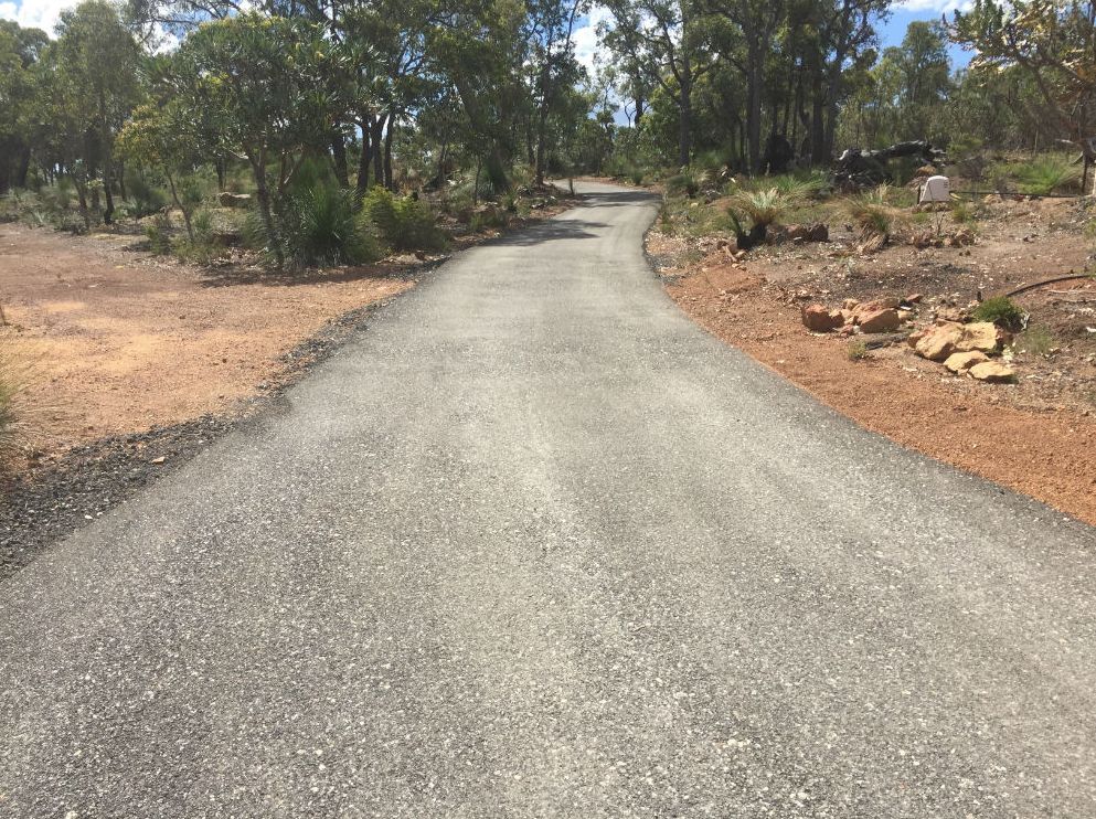 This is a photo of a hot spray & seal bitumen driveway which is in the process of being installed by Yarrambat Surfacing Solutions